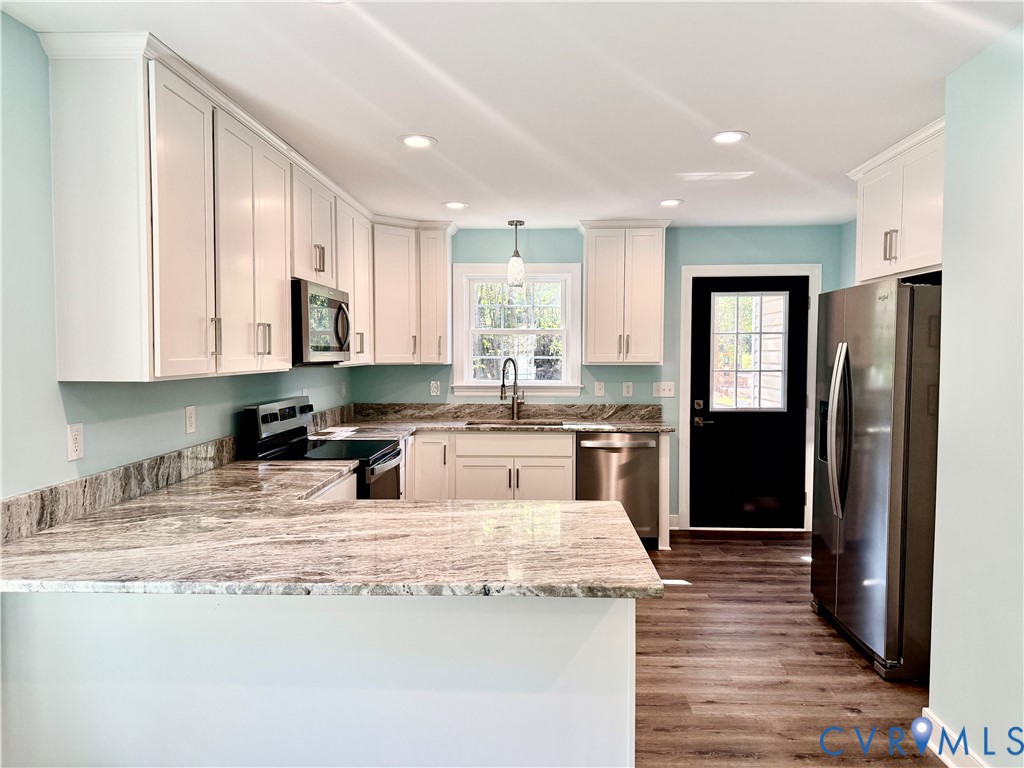 26 Tupelo Street Deltaville, VA 23043 - Photo 4 of 38 a kitchen with stainless steel appliances granite countertop a refrigerator and a stove top oven