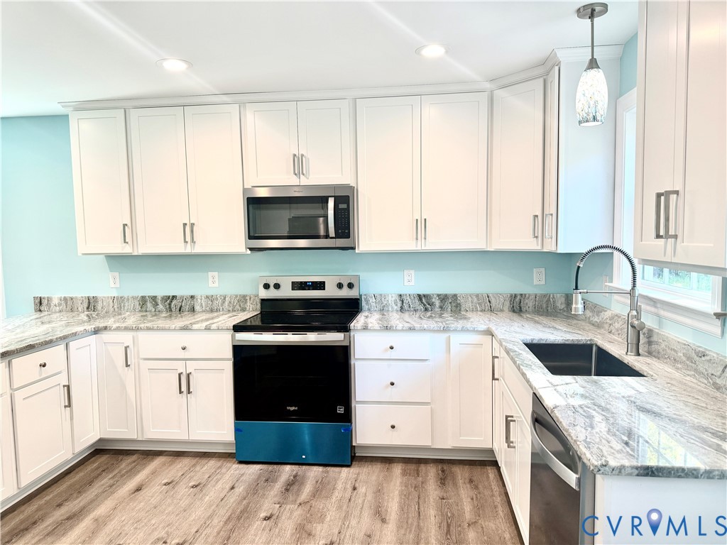 26 Tupelo Street Deltaville, VA 23043 - Photo 7 of 38 a kitchen with a sink stove top oven and cabinets