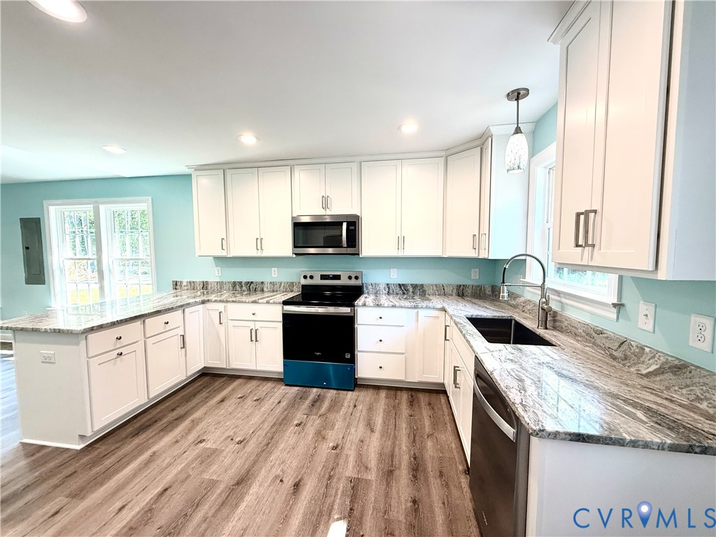 26 Tupelo Street Deltaville, VA 23043 - Photo 8 of 38 a kitchen with granite countertop a sink a counter top space stainless steel appliances and cabinets
