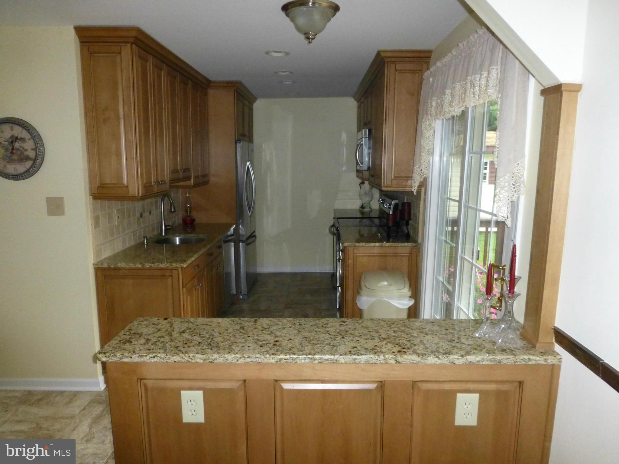 9317 Perglen Road Baltimore, MD 21236 - Photo 3 of 23 a bathroom with a granite countertop sink and a mirror