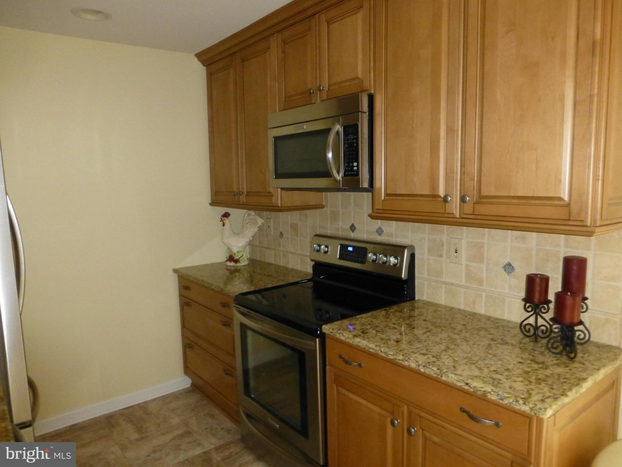 9317 Perglen Road Baltimore, MD 21236 - Photo 4 of 23 a kitchen with a stove and a microwave