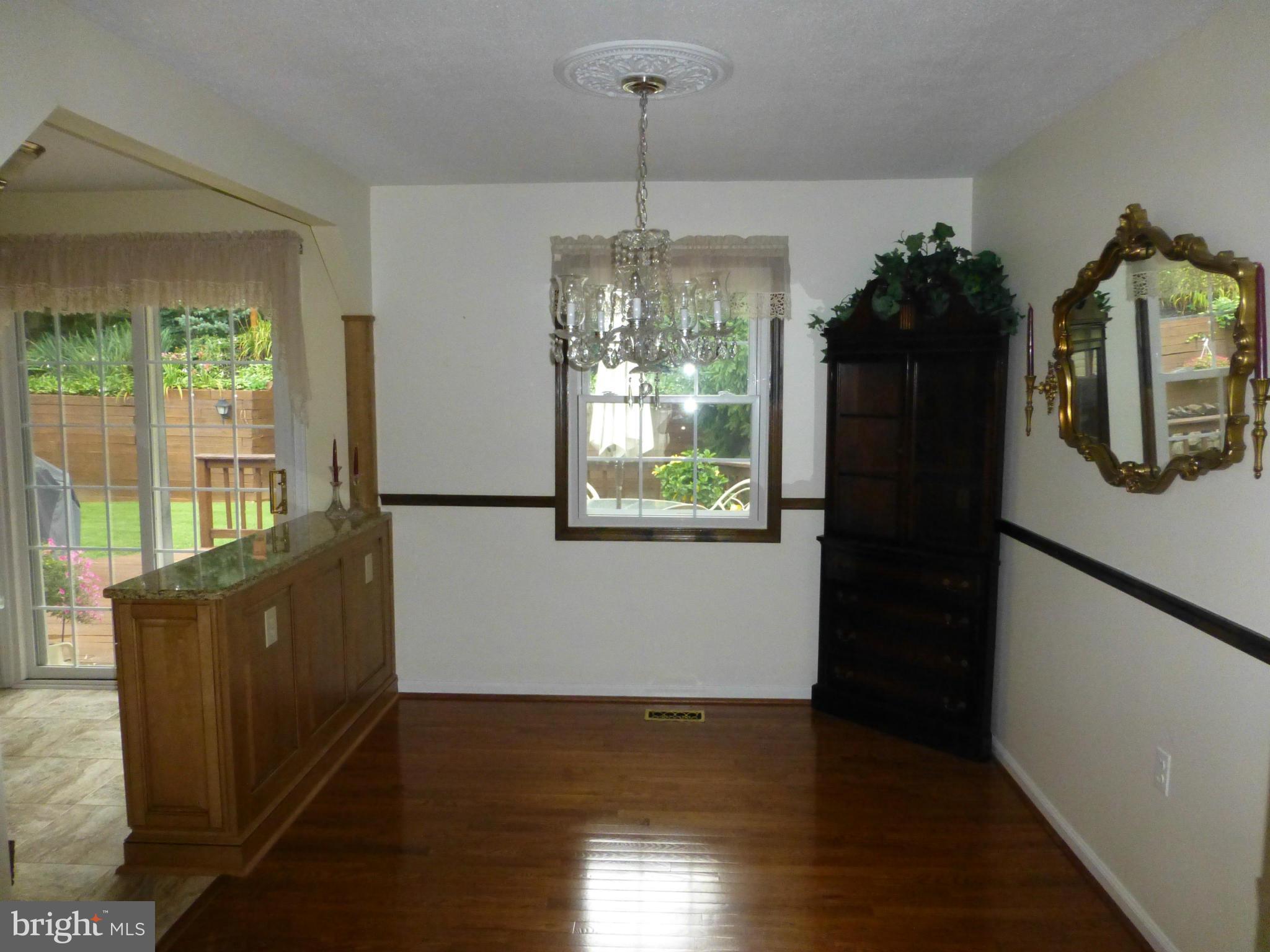 9317 Perglen Road Baltimore, MD 21236 - Photo 7 of 23 a view of a kitchen with a window and wooden floor