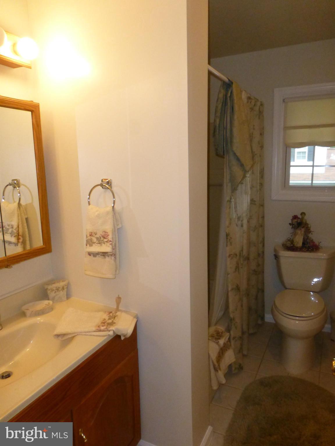 9317 Perglen Road Baltimore, MD 21236 - Photo 9 of 23 a bathroom with a sink toilet and shower