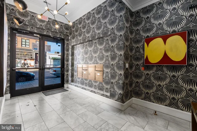 a view of entryway with a big yard and potted plants