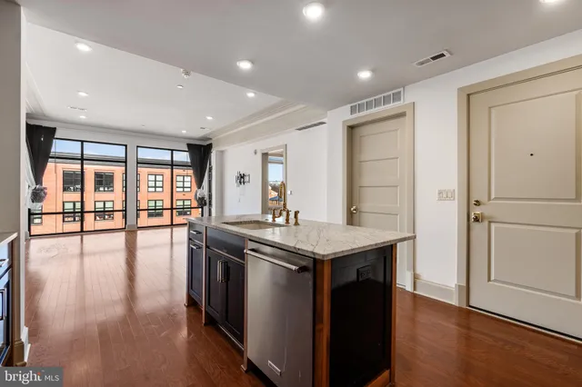 a kitchen with stainless steel appliances granite countertop a stove and a refrigerator
