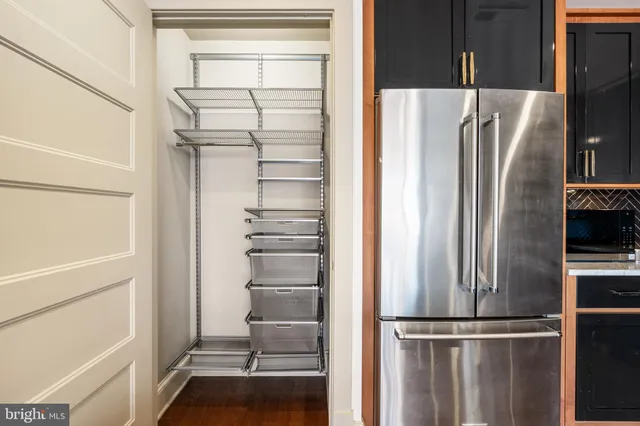 a view of walk in closet with empty racks