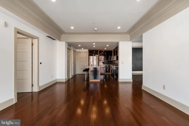 a view of a hallway with wooden floor
