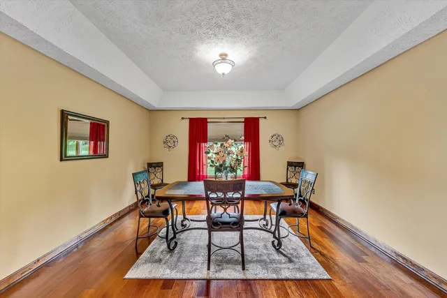 a view of a dining room with furniture and wooden floor