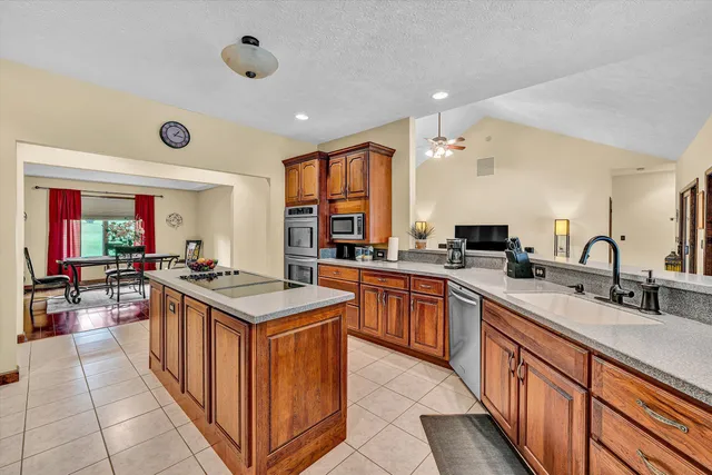a kitchen with stainless steel appliances granite countertop a sink and a stove