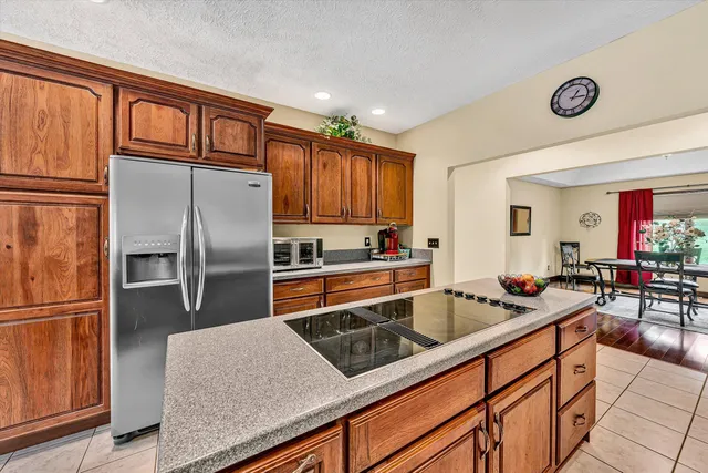 a kitchen with stainless steel appliances granite countertop a refrigerator and a sink