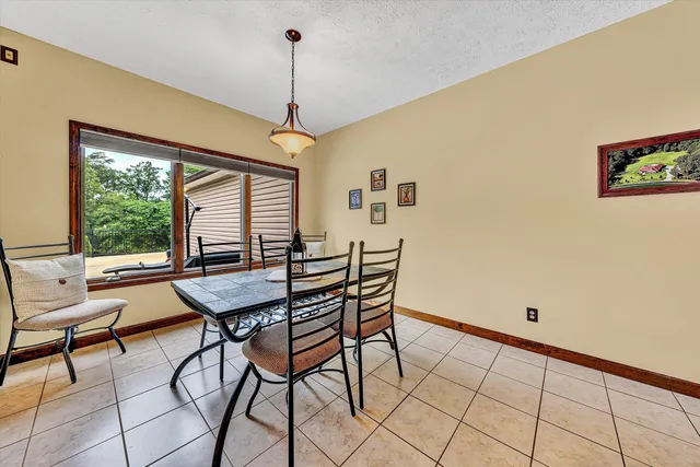 a view of a dining room with furniture window and outside view