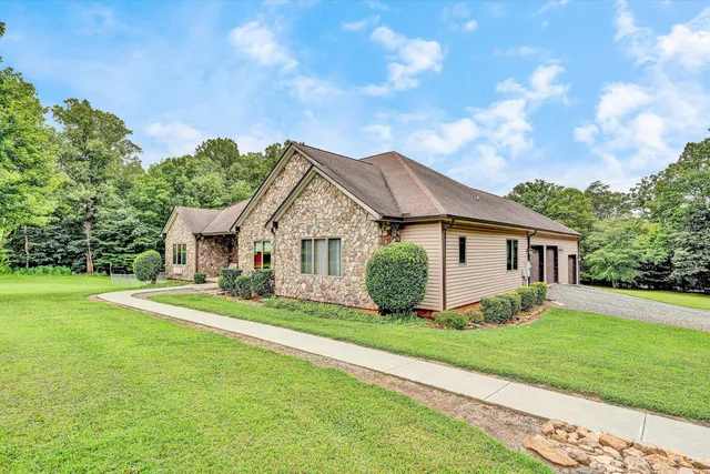 a view of a house with yard and a garden