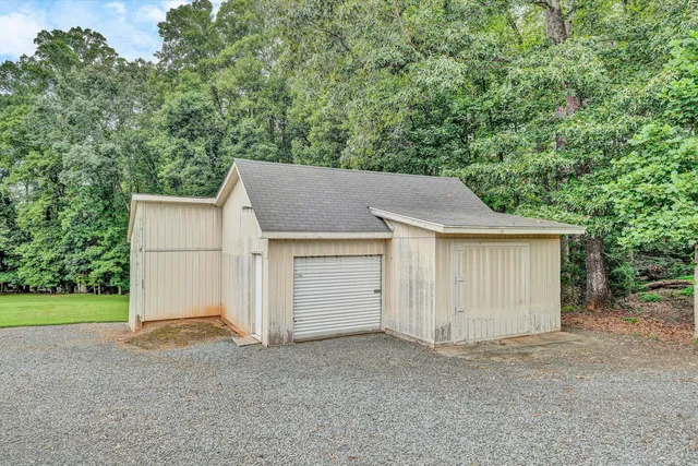 a view of an house with backyard and pool