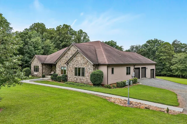 a view of house that has a yard