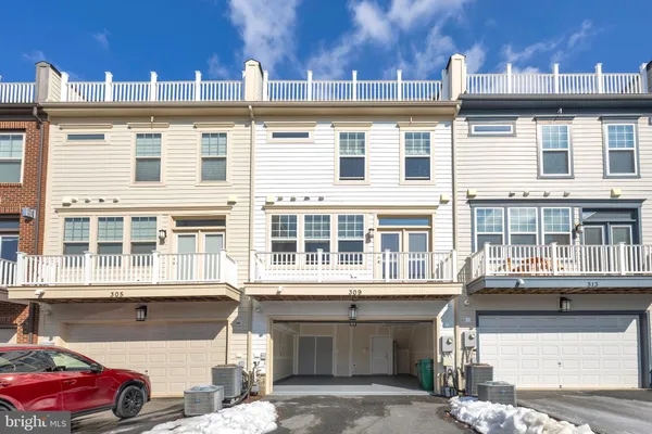 a front view of a residential apartment building with a yard