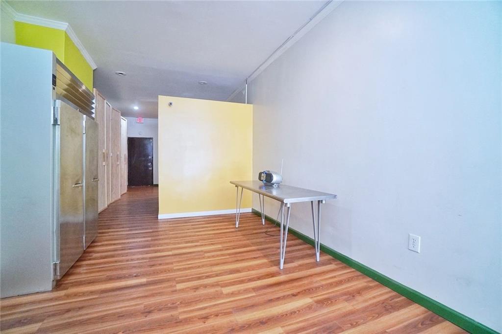533 Sutter Avenue Brooklyn, NY 11207 - Photo 6 of 18 a view of a hallway with wooden floor