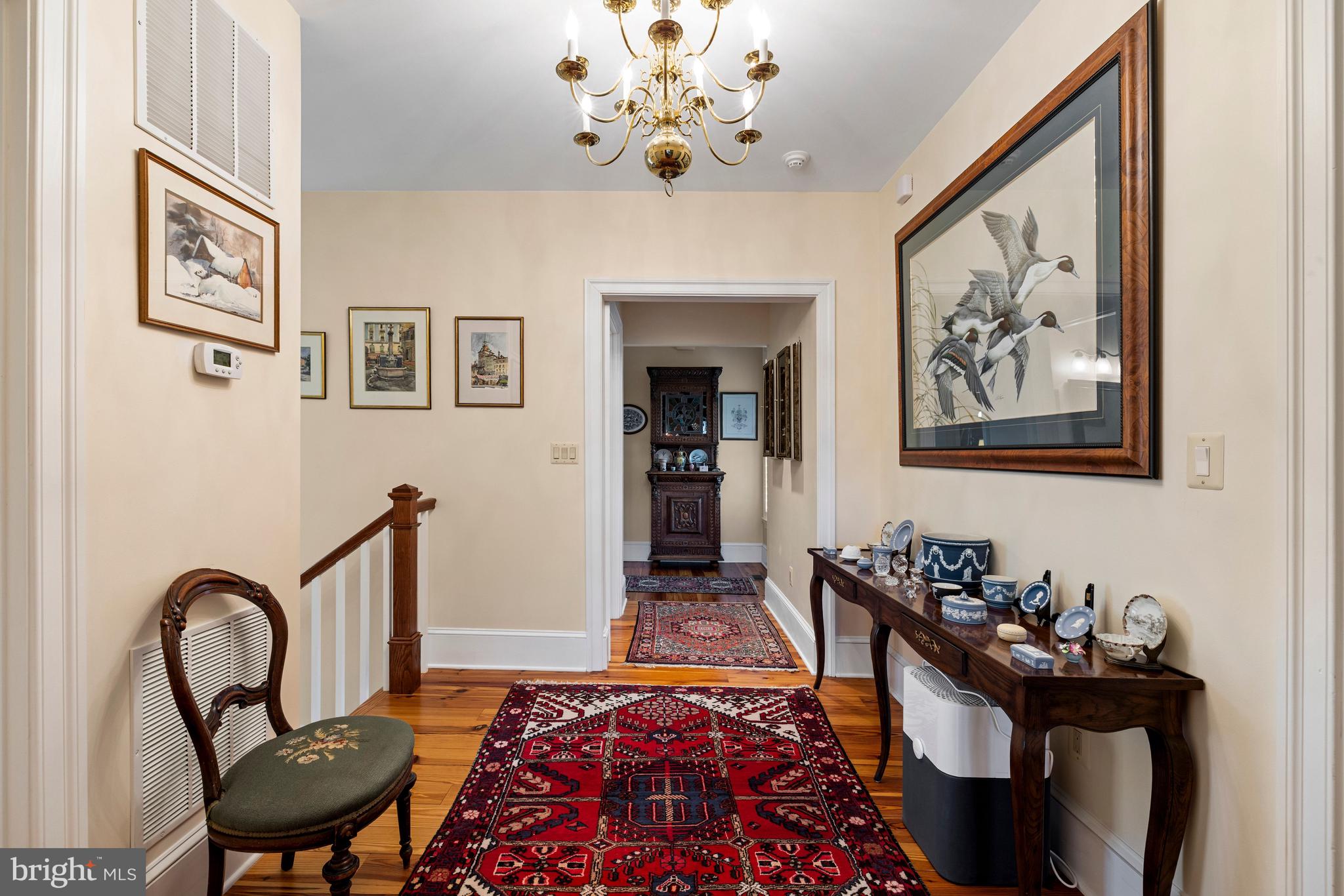 20147 Woodtrail Road Round Hill, VA 20141 - Photo 20 of 41 a bedroom with furniture and a chandelier