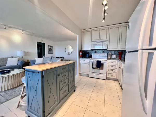 a kitchen with stainless steel appliances sink stove microwave and cabinets