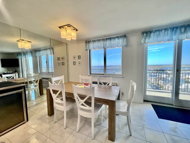a view of a dining room with furniture and a kitchen