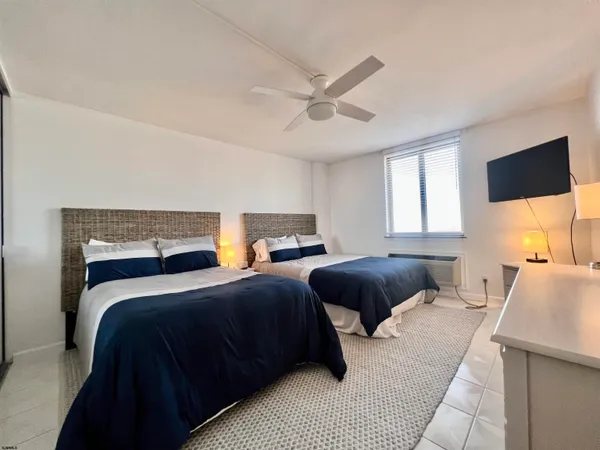 a bedroom with two beds and a couch