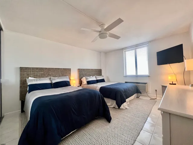 a bedroom with two beds and a couch