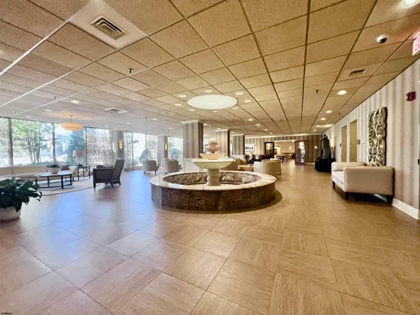 a large room with lots of furniture and a chandelier