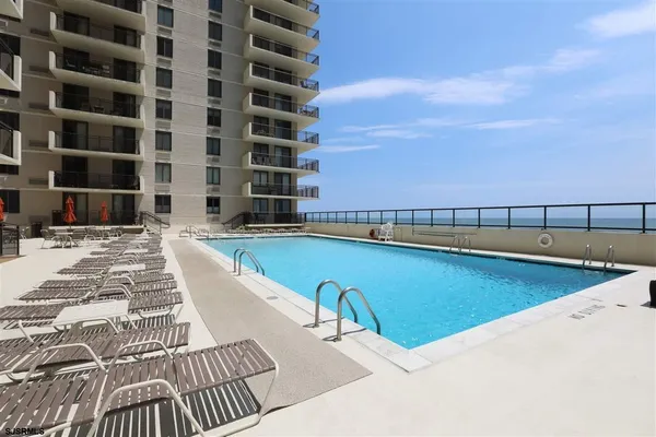 a view of a swimming pool with a lounge chairs