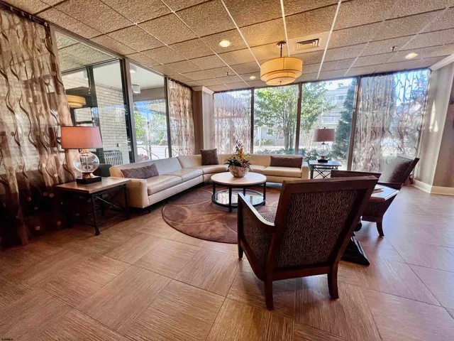 a living room with furniture and a floor to ceiling window