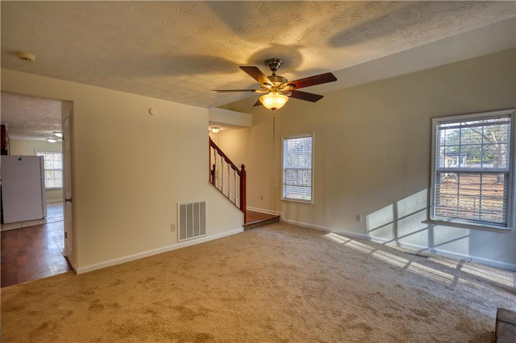 2475 Nugget Drive Southwest Conyers, GA 30094 - Photo 12 of 47 a view of a livingroom with a ceiling fan and window