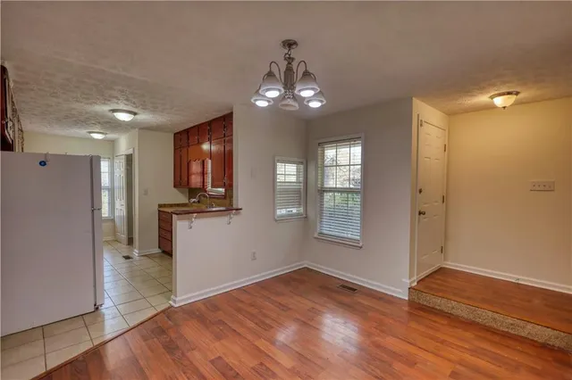 a kitchen that has a sink a stove and a microwave