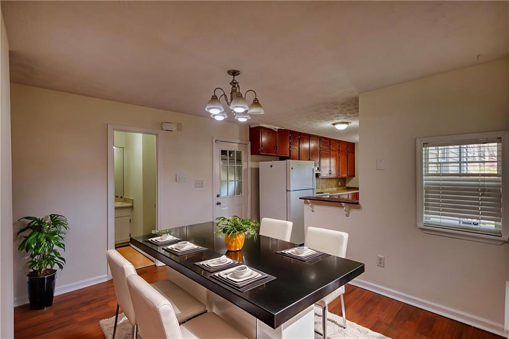 2475 Nugget Drive Southwest Conyers, GA 30094 - Photo 15 of 47 a view of a dining room with furniture and wooden floor