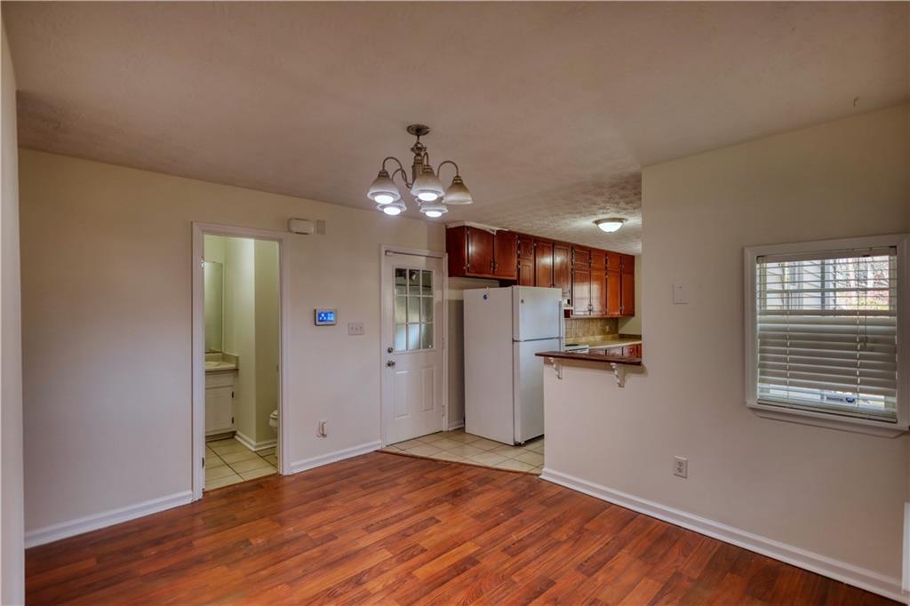 2475 Nugget Drive Southwest Conyers, GA 30094 - Photo 16 of 47 a view of a kitchen with a sink a refrigerator and wooden floor