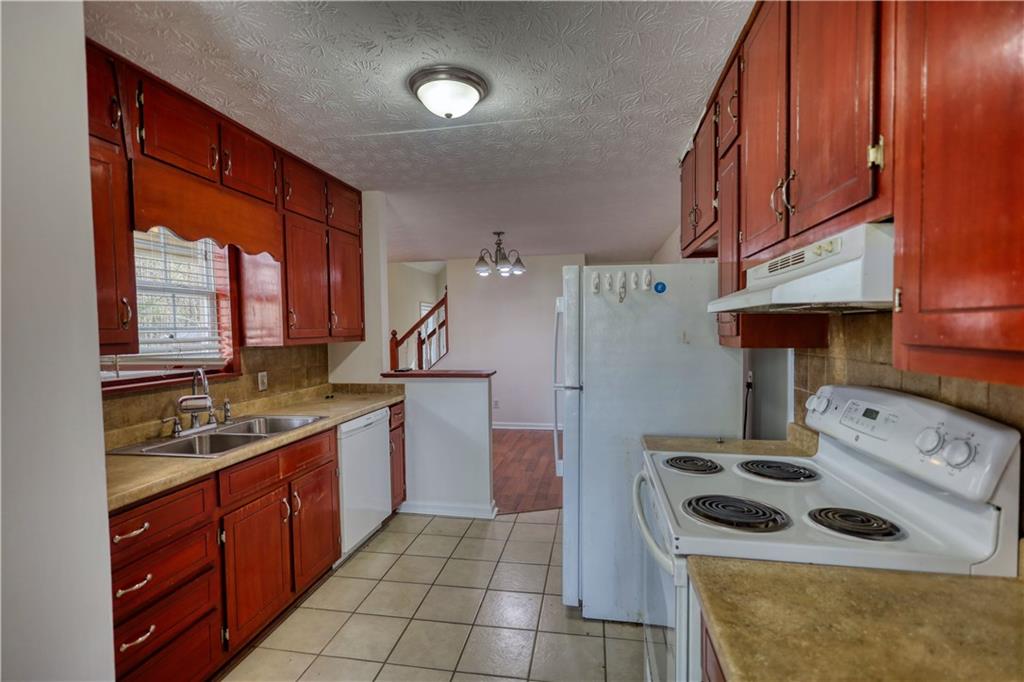 2475 Nugget Drive Southwest Conyers, GA 30094 - Photo 22 of 47 a kitchen that has a sink a stove and a microwave