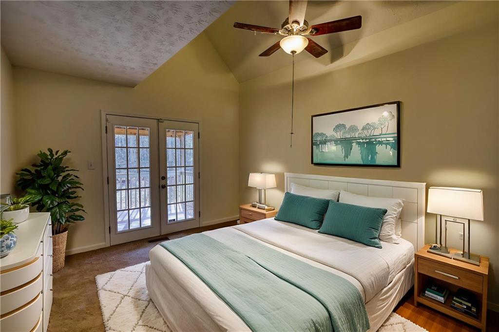 2475 Nugget Drive Southwest Conyers, GA 30094 - Photo 25 of 47 a bedroom with a large bed and a chandelier