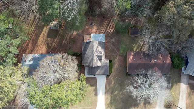 a aerial view of a house with a yard and fountain