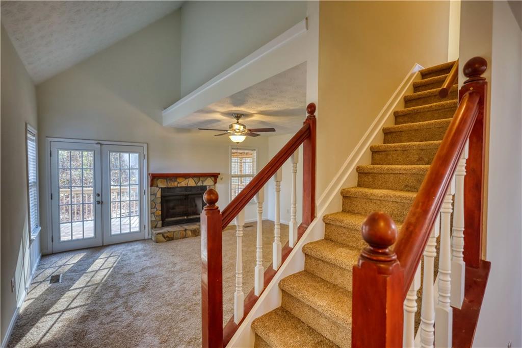 2475 Nugget Drive Southwest Conyers, GA 30094 - Photo 9 of 47 a view of staircase with lots of frames on wall and windows