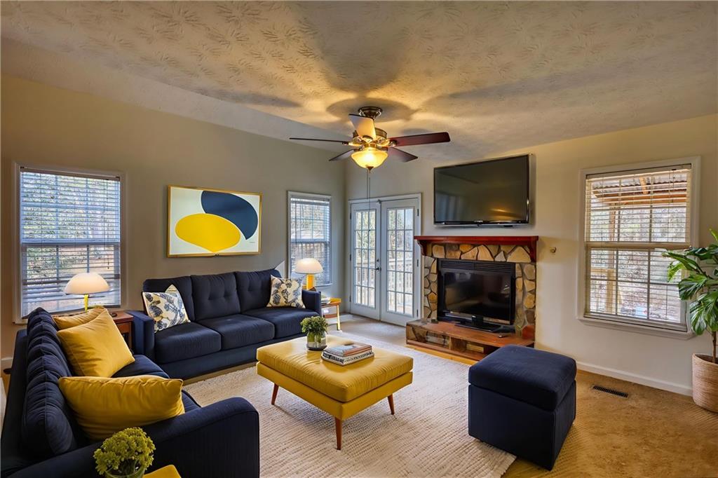 2475 Nugget Drive Southwest Conyers, GA 30094 - Photo 10 of 47 a living room with furniture a fireplace and a flat screen tv