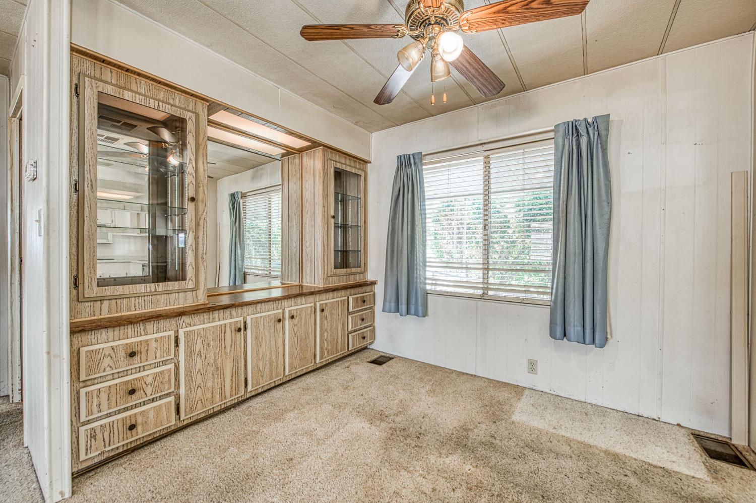 1300 West Olson Avenue, Unit 75 Reedley, CA 93654 - Photo 11 of 40 an empty room with windows and fan