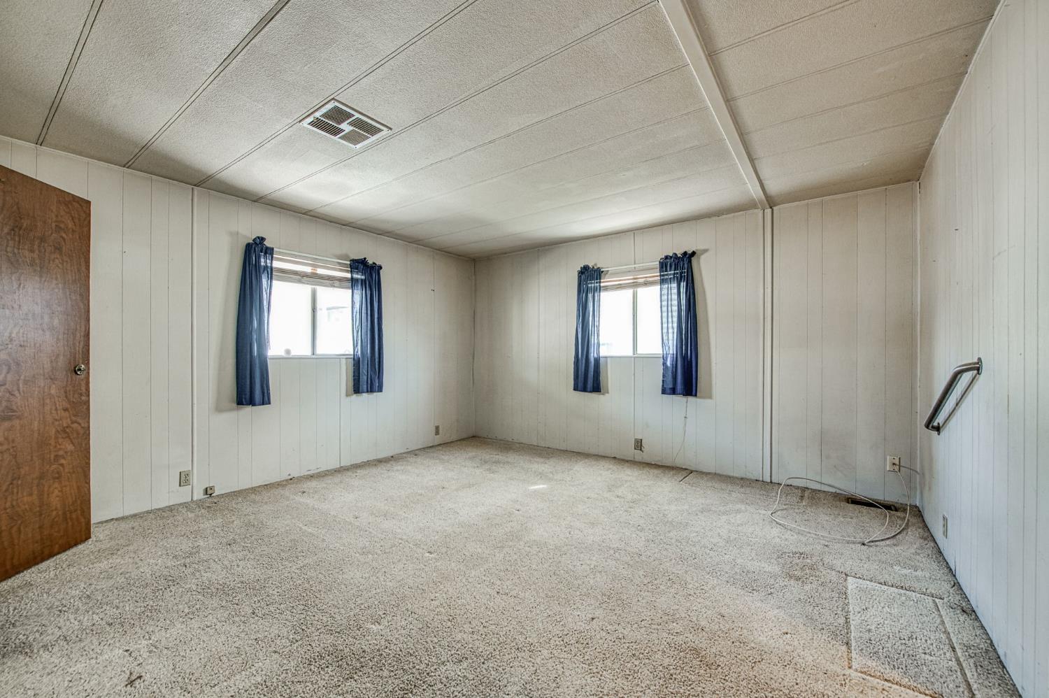 1300 West Olson Avenue, Unit 75 Reedley, CA 93654 - Photo 17 of 40 a view of empty room with windows
