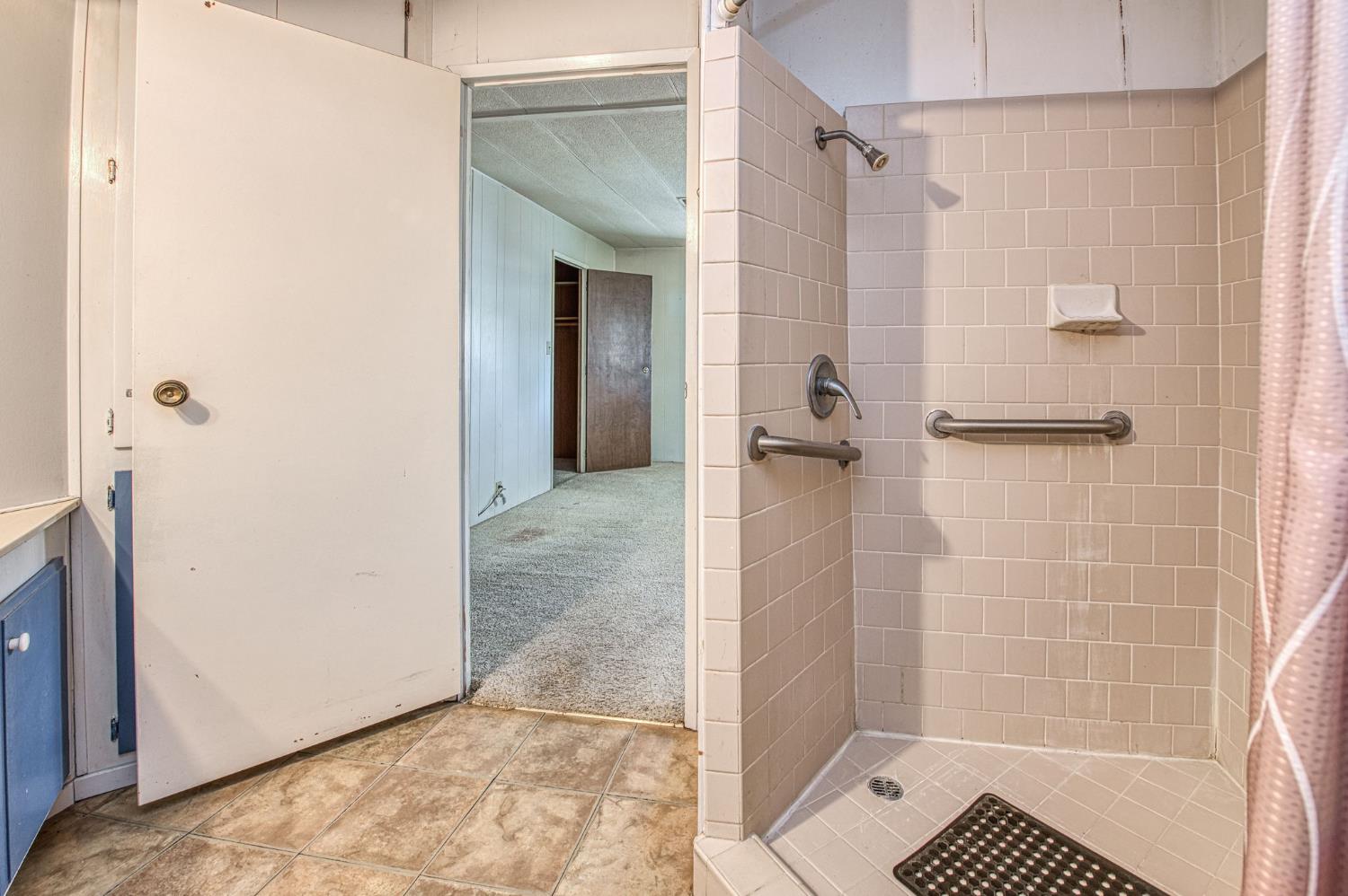 1300 West Olson Avenue, Unit 75 Reedley, CA 93654 - Photo 21 of 40 a bathroom with a shower and a glass door