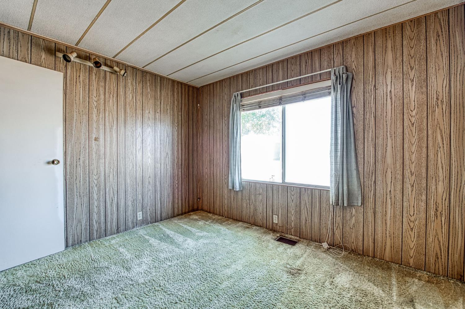 1300 West Olson Avenue, Unit 75 Reedley, CA 93654 - Photo 23 of 40 a view of an empty room with a window