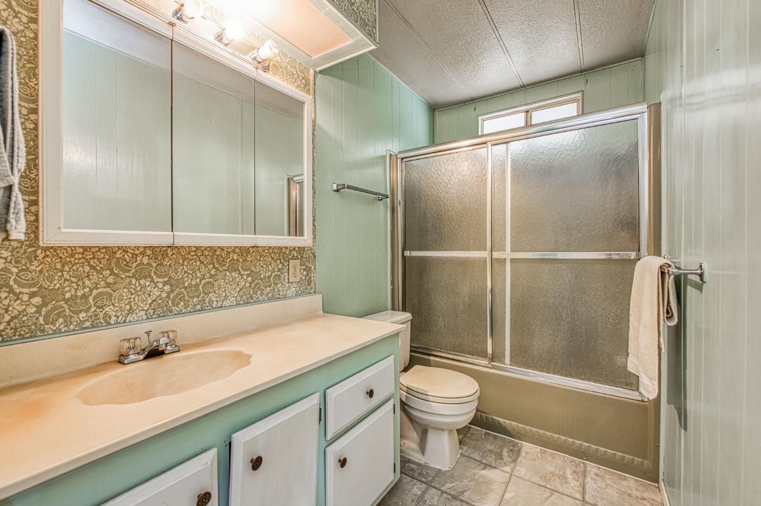 1300 West Olson Avenue, Unit 75 Reedley, CA 93654 - Photo 26 of 40 a bathroom with a sink toilet and shower