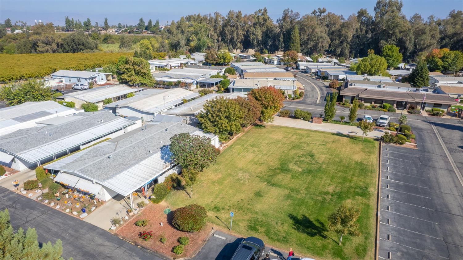 1300 West Olson Avenue, Unit 75 Reedley, CA 93654 - Photo 28 of 40 an aerial view of a swimming pool with outdoor seating