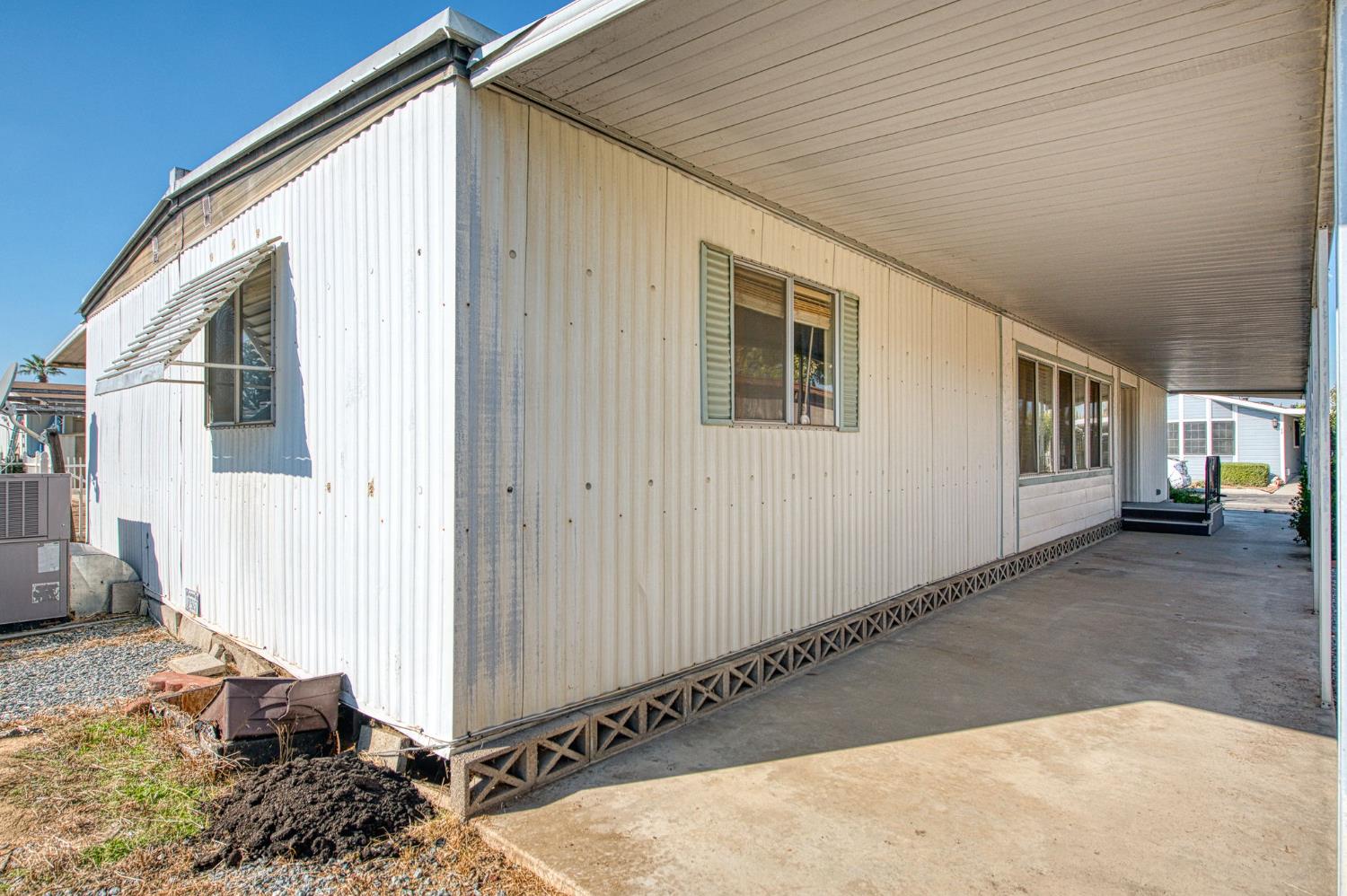 1300 West Olson Avenue, Unit 75 Reedley, CA 93654 - Photo 6 of 40 a view of a house with a backyard