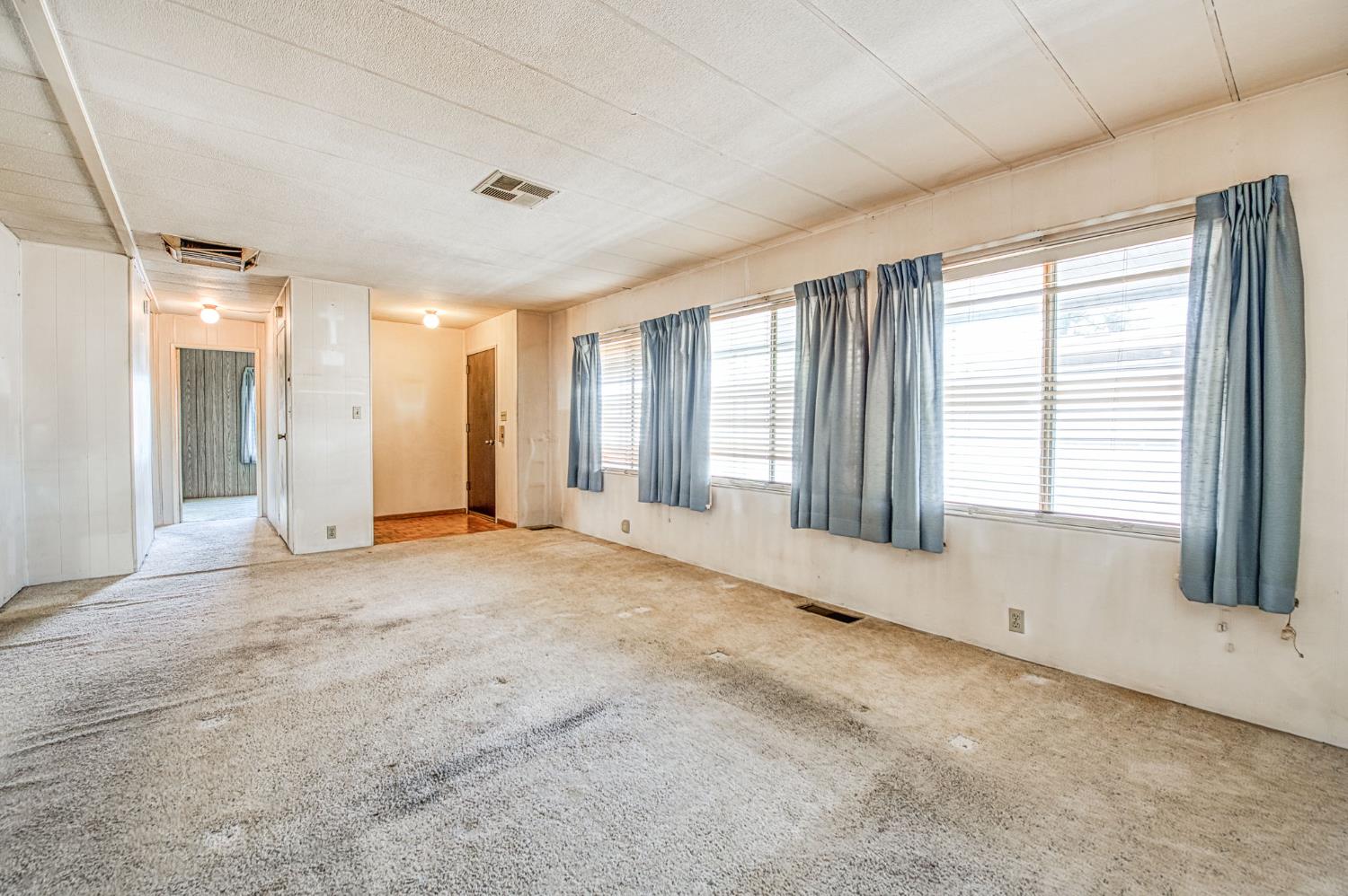 1300 West Olson Avenue, Unit 75 Reedley, CA 93654 - Photo 8 of 40 a view of an empty room with a window