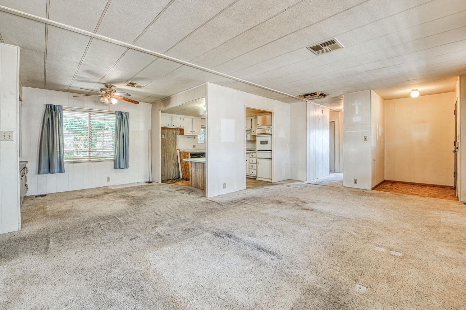 1300 West Olson Avenue, Unit 75 Reedley, CA 93654 - Photo 9 of 40 an empty room with a empty space and windows