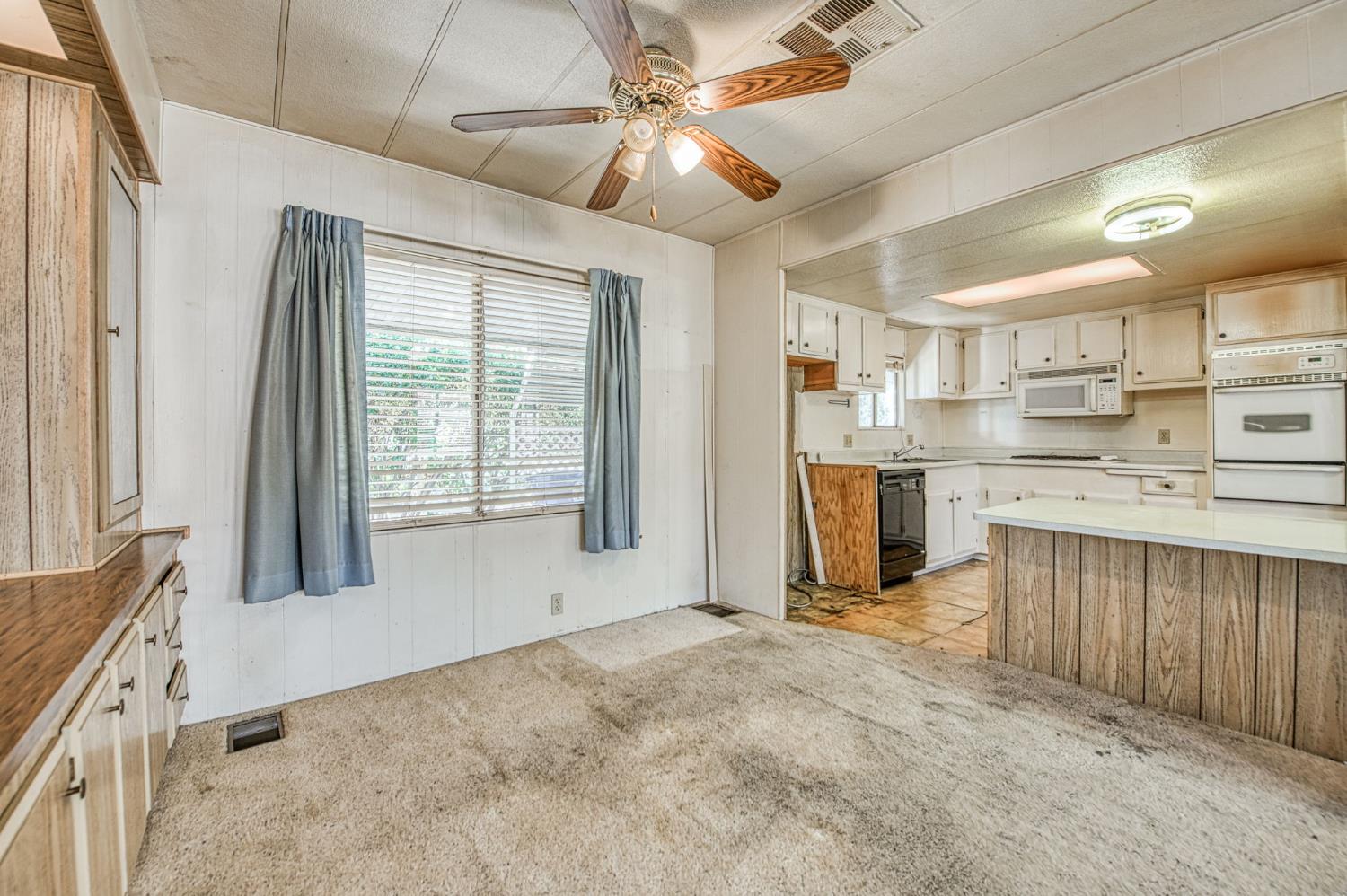 1300 West Olson Avenue, Unit 75 Reedley, CA 93654 - Photo 10 of 40 a view of a kitchen with microwave and a stove