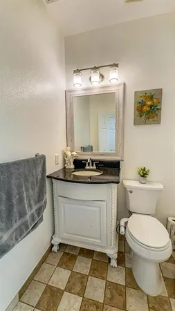 a bathroom with a sink mirror and toilet