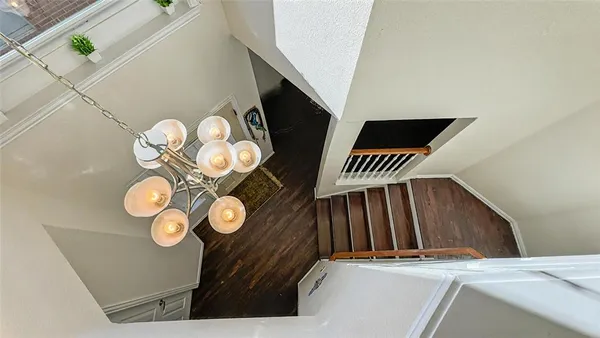 a view of staircase with door and a rug