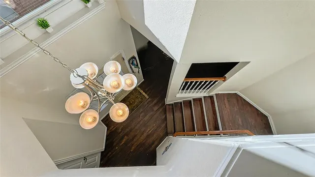 a view of staircase with door and a rug